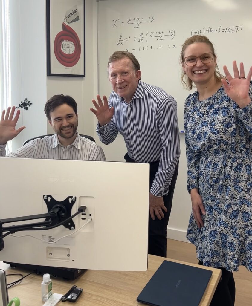 The Web Bird Digital team smiling and waving hello in the office