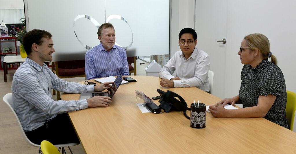 The Web Bird Digital team in a meeting around the boardroom table